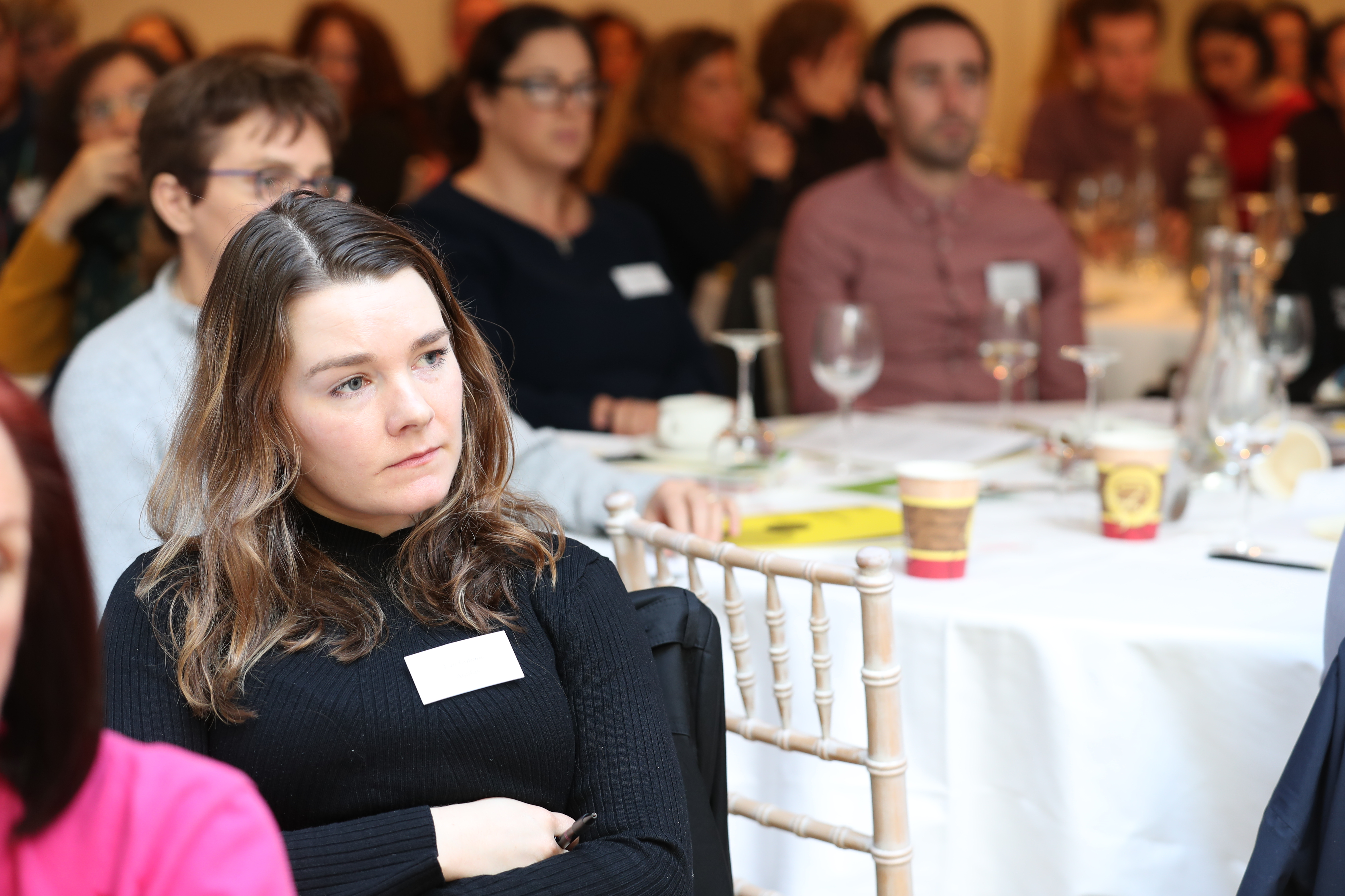 Attendee listening to presentation
