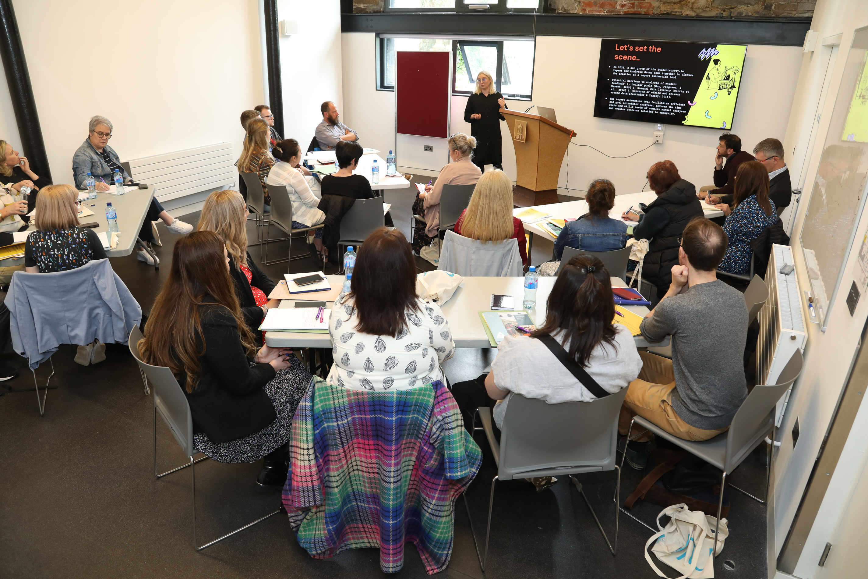 Photograph of Dr Lydia Devenney presenting on the Report Automation Tool at the Practitioners Forum 2022