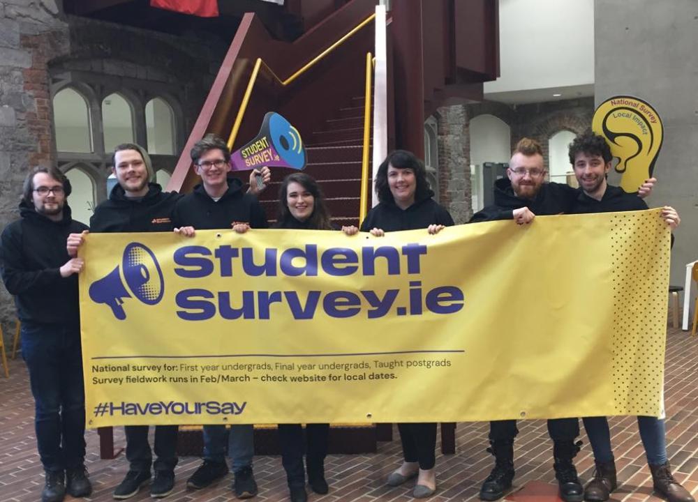 Students in UCC holding StudentSurvey.ie banner