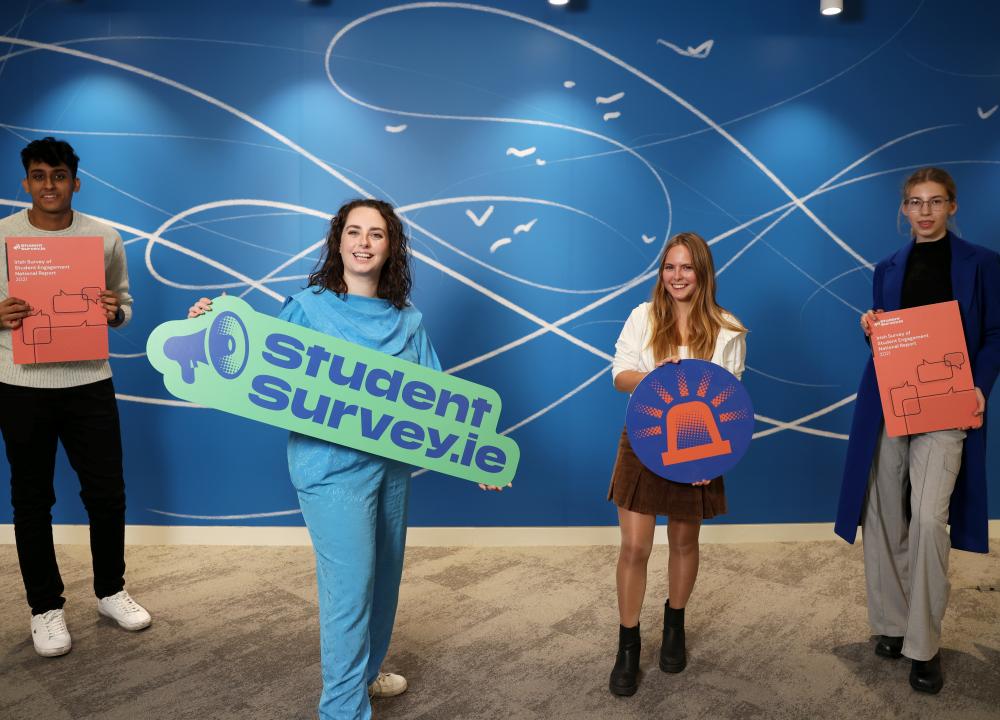 Senator Annie Hoey and three second year students holding signs